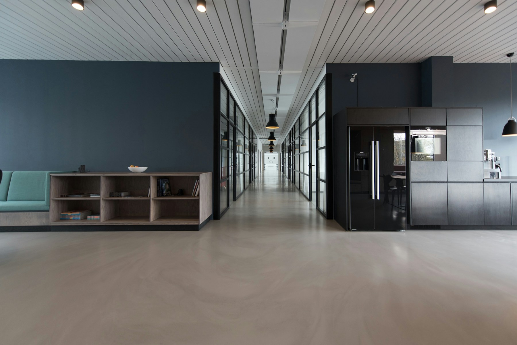 AdSwift Haven studio interior at night, warm desk lamps over editorial boards